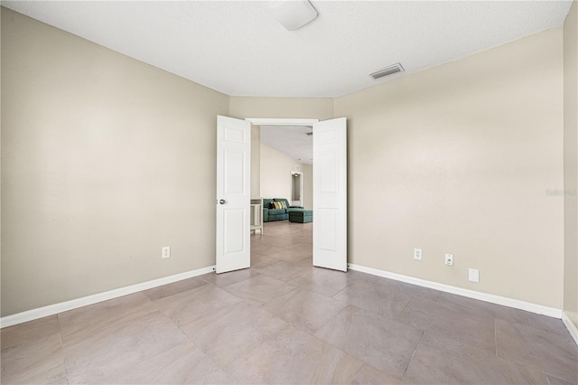 empty room featuring a textured ceiling