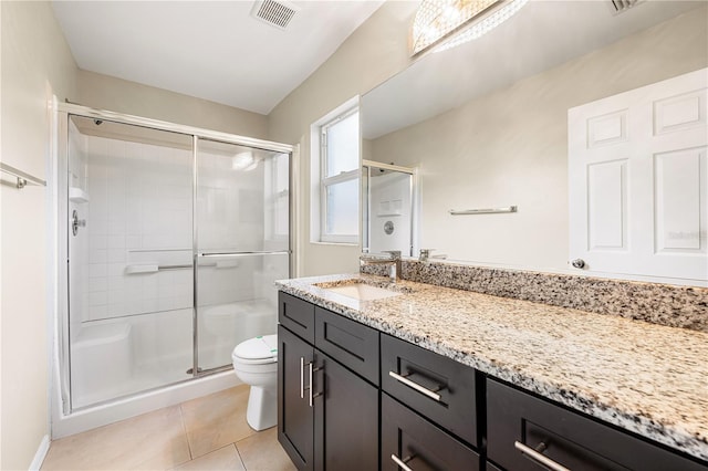 bathroom featuring tile patterned flooring, vanity, an enclosed shower, and toilet