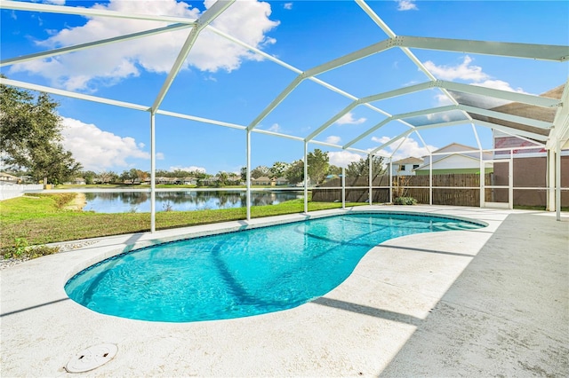 view of swimming pool featuring a water view, a yard, a patio area, and glass enclosure