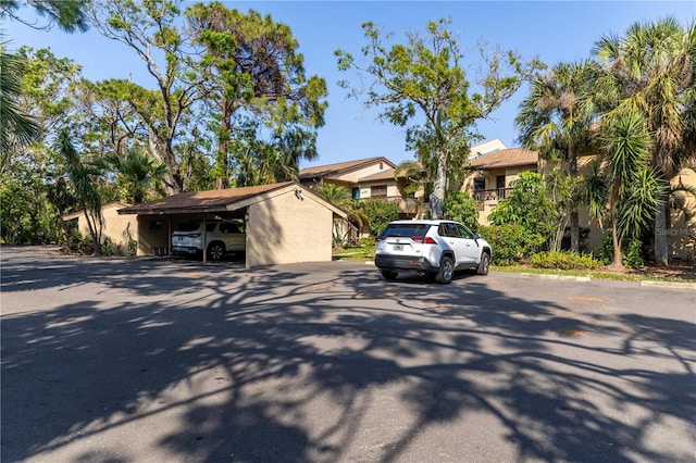 view of front of home featuring uncovered parking and stucco siding