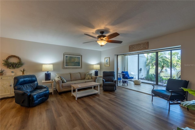 living area featuring ceiling fan, wood finished floors, and a textured ceiling