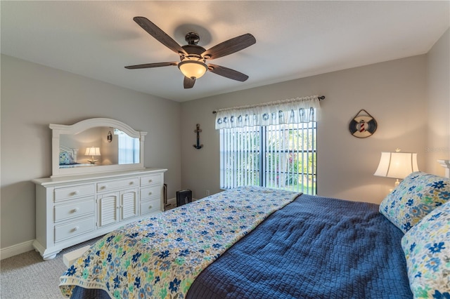 bedroom featuring baseboards, light carpet, and ceiling fan