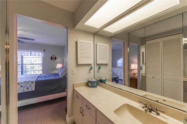 ensuite bathroom with vanity, ensuite bath, a closet, and ceiling fan