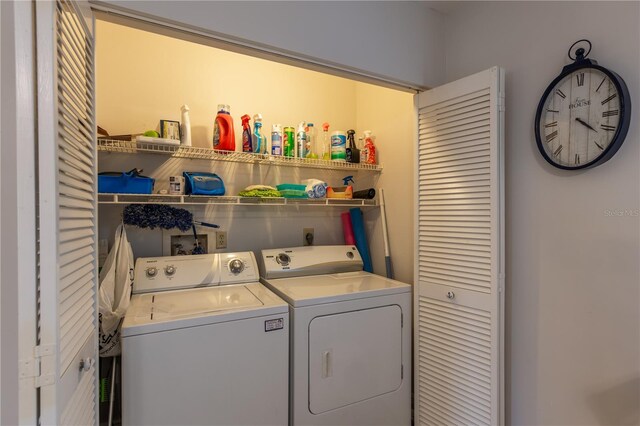 washroom featuring laundry area and washing machine and clothes dryer