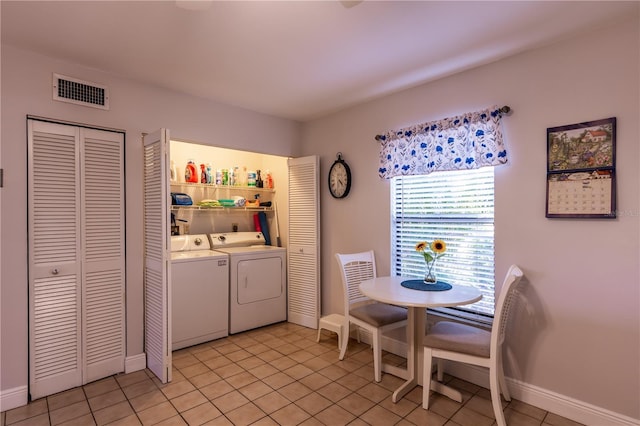 laundry room featuring visible vents, baseboards, washer and clothes dryer, laundry area, and light tile patterned flooring