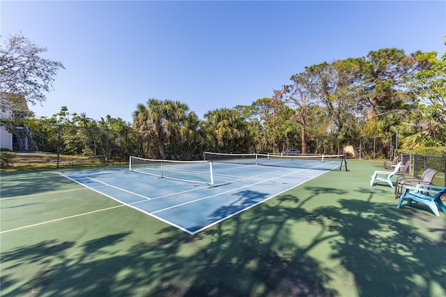 view of tennis court featuring fence