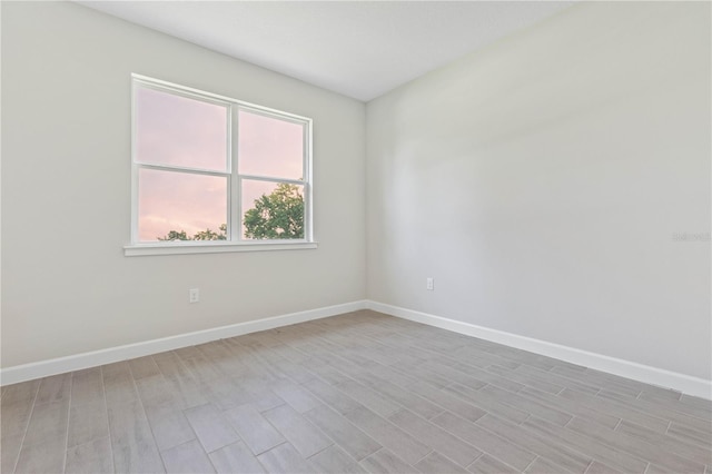 spare room with light hardwood / wood-style flooring