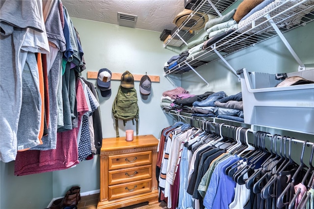 walk in closet with wood finished floors and visible vents