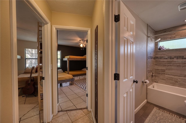 bathroom with shower / bath combination, a healthy amount of sunlight, ensuite bath, and tile patterned floors