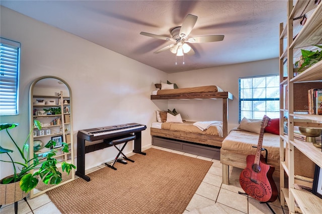 bedroom featuring ceiling fan and tile patterned floors