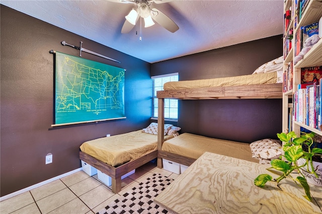 bedroom featuring ceiling fan, tile patterned flooring, and baseboards