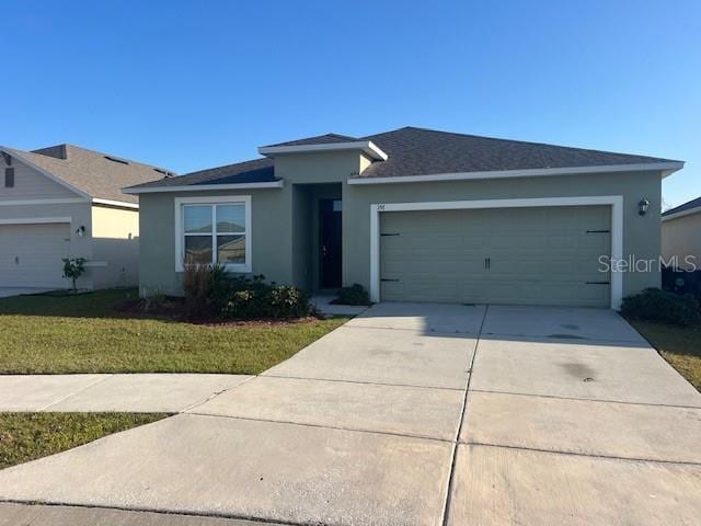 view of front of property featuring a garage and a front yard