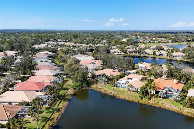 drone / aerial view featuring a residential view and a water view