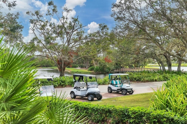 view of community featuring a yard and a water view