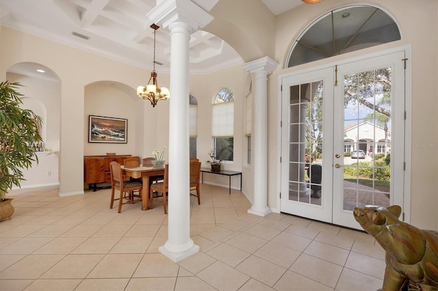 dining room with light tile patterned flooring, coffered ceiling, baseboards, ornate columns, and crown molding