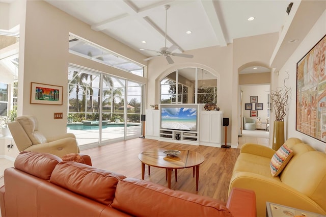 living area with light wood finished floors, coffered ceiling, ceiling fan, beamed ceiling, and recessed lighting