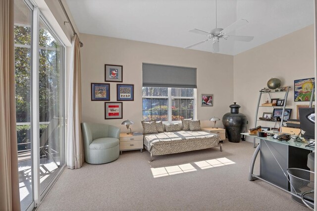 bedroom with access to outside, multiple windows, ceiling fan, and carpet flooring