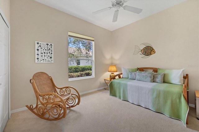 carpeted bedroom featuring a ceiling fan, a closet, and baseboards