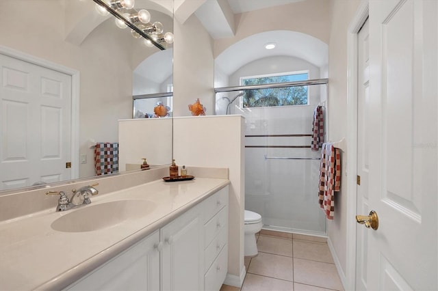 full bath featuring toilet, a stall shower, vanity, and tile patterned floors