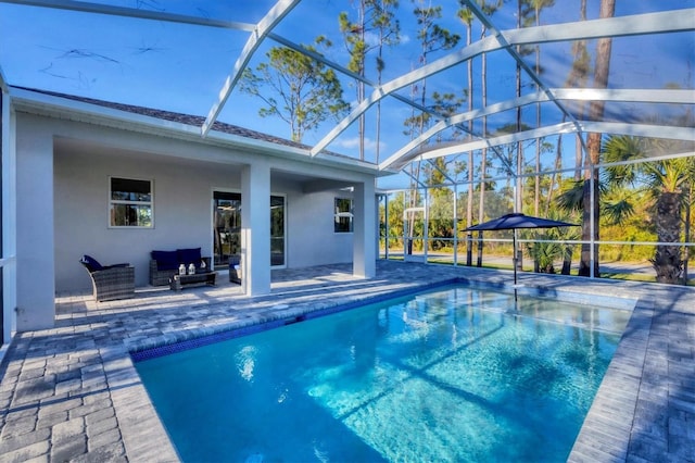 view of pool featuring a lanai, outdoor lounge area, and a patio