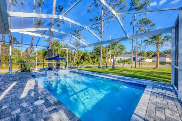 view of pool featuring a patio, glass enclosure, and a lawn