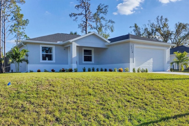 single story home featuring a garage and a front lawn