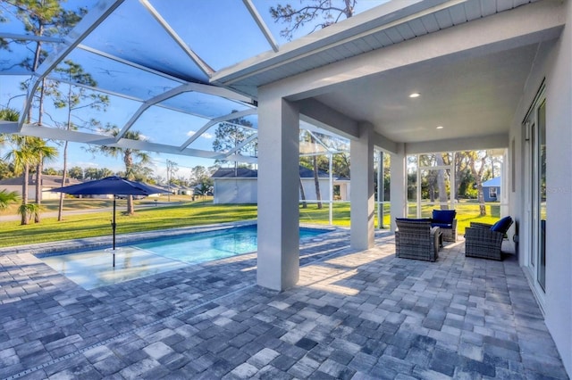 view of pool with a lanai, a lawn, outdoor lounge area, and a patio area