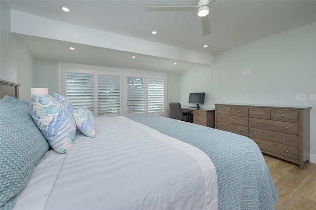 bedroom with ceiling fan, light hardwood / wood-style floors, and vaulted ceiling with beams