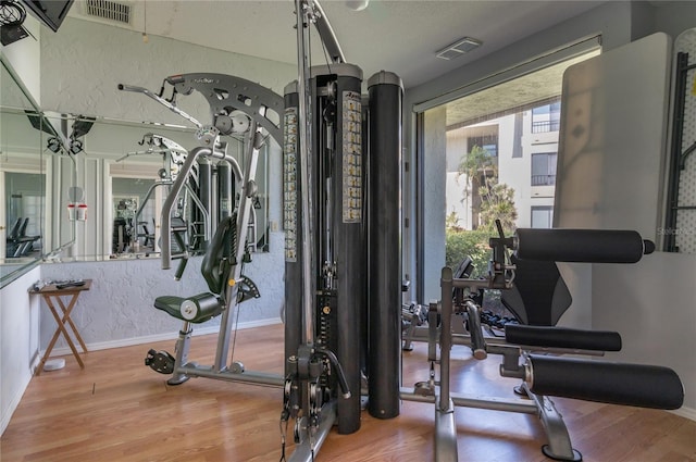 gym featuring light wood-type flooring