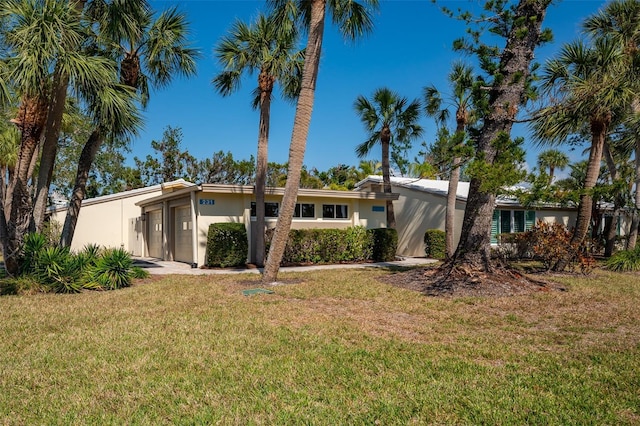 view of front facade with a garage and a front lawn