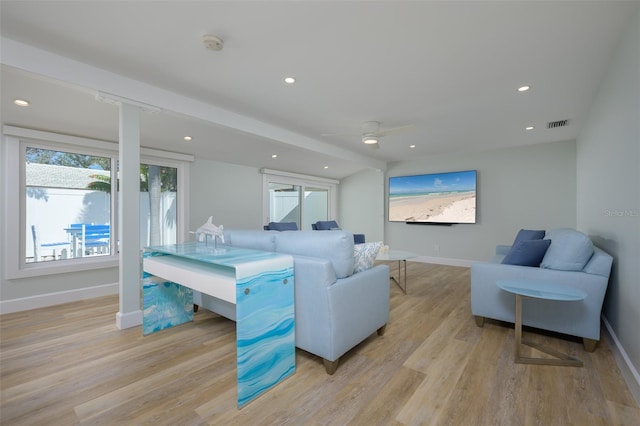 living room featuring ceiling fan and light wood-type flooring