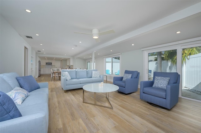 living room with ceiling fan and light hardwood / wood-style floors