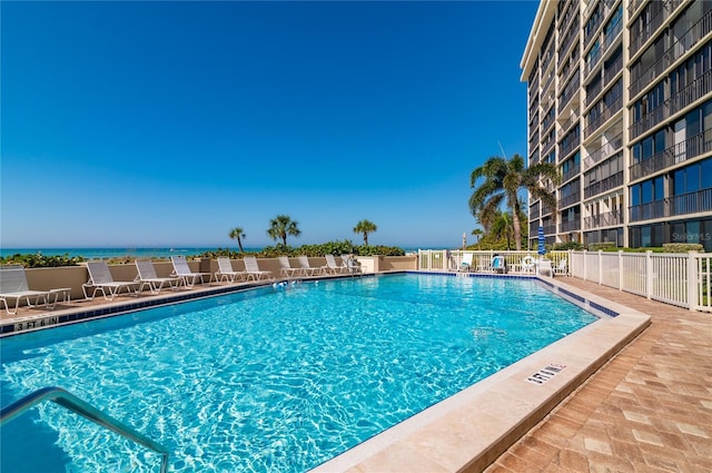 view of pool with a water view