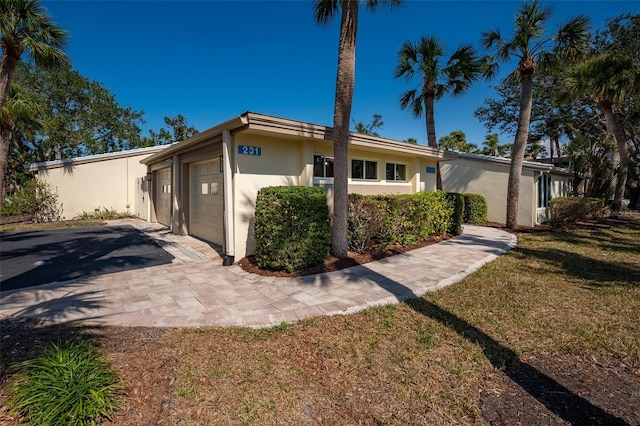 view of front of house with a garage and a front lawn