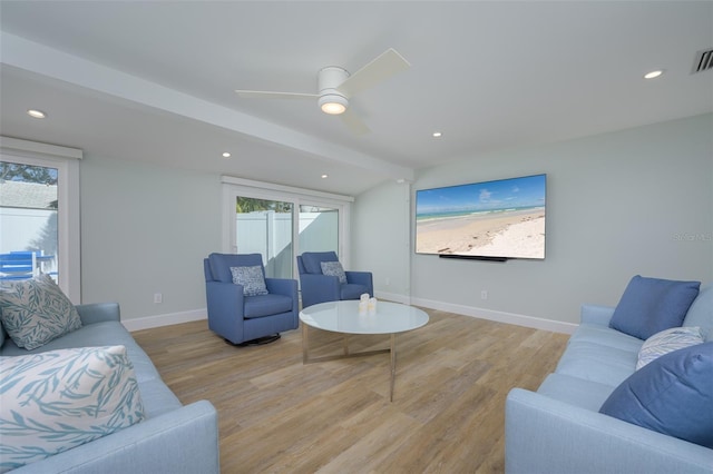 living room with ceiling fan and light hardwood / wood-style flooring