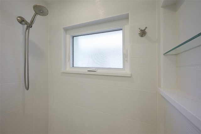 bathroom with tiled shower