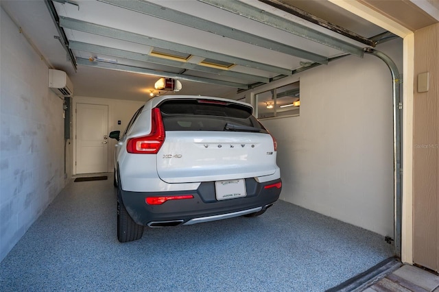 garage with a wall mounted air conditioner and a garage door opener