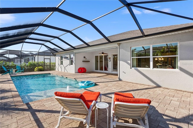 view of swimming pool with a patio area, ceiling fan, a lanai, and pool water feature