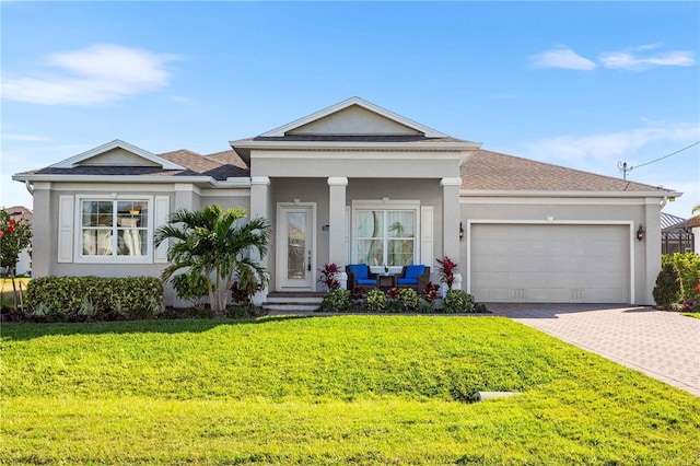 view of front of home featuring a garage and a front yard