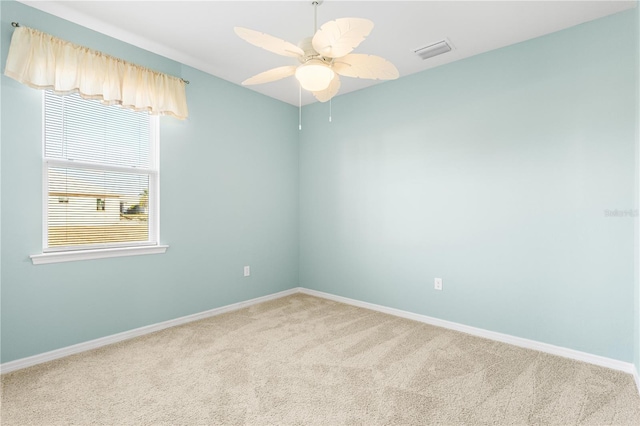 carpeted empty room featuring ceiling fan