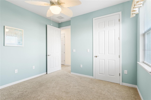 unfurnished bedroom with light carpet and ceiling fan