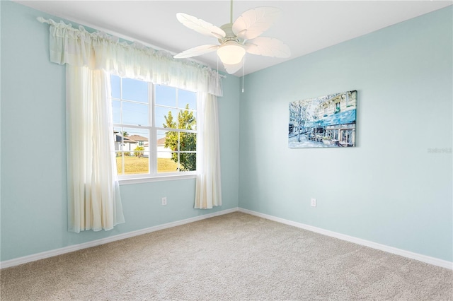 spare room featuring carpet floors and ceiling fan