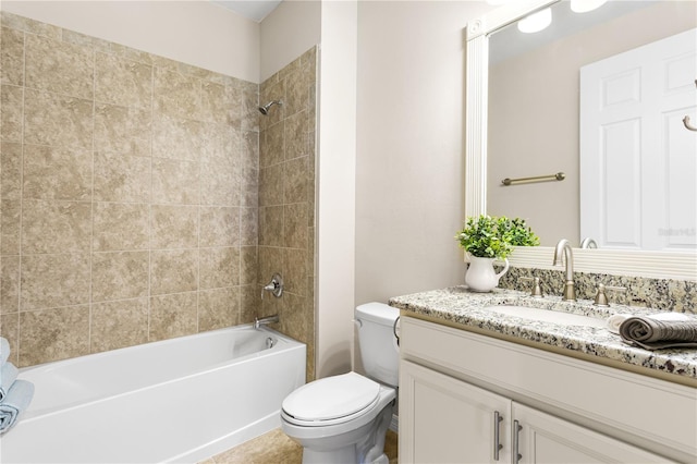 full bathroom featuring tiled shower / bath combo, vanity, and toilet