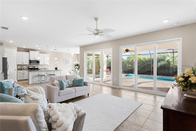 tiled living room with ceiling fan