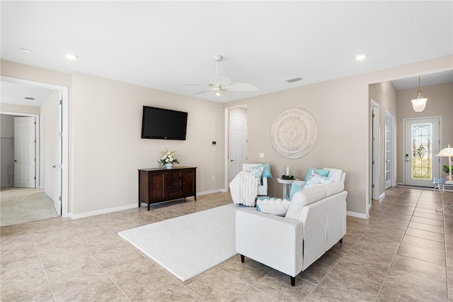 tiled living room featuring ceiling fan