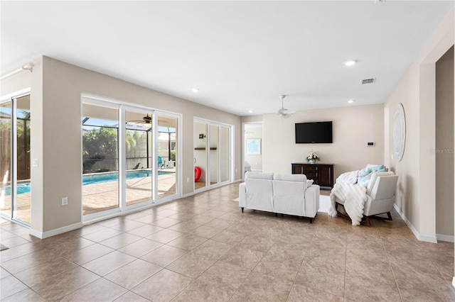 living room featuring light tile patterned flooring and ceiling fan