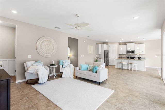 tiled living room with ceiling fan