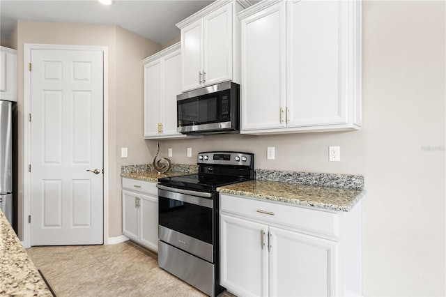 kitchen with stainless steel appliances, light stone countertops, and white cabinets