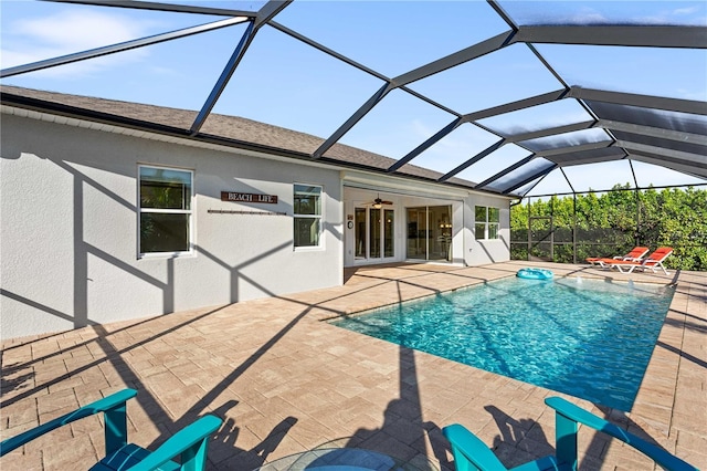 view of swimming pool featuring a patio, a lanai, and ceiling fan