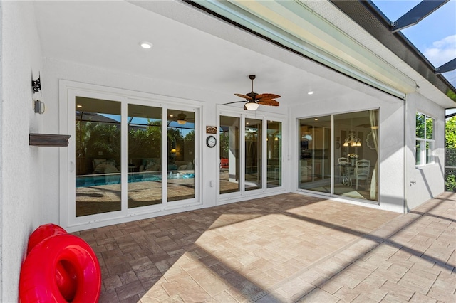 view of patio with ceiling fan and a lanai